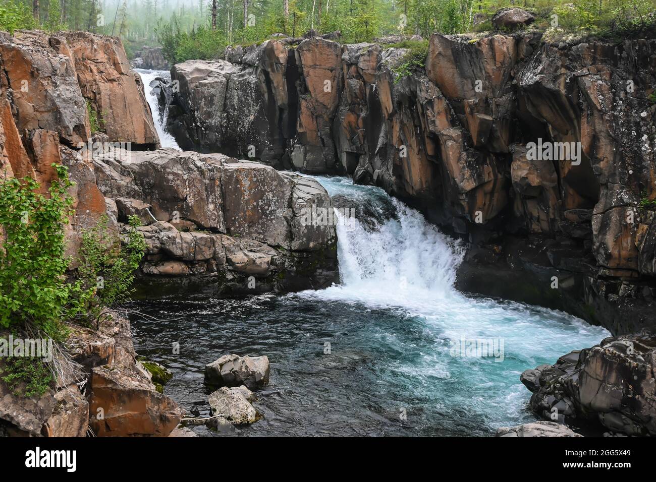 Putorana Plateau, a waterfall on the Grayling Stream. Mountain stream on a  cloudy day Stock Photo - Alamy