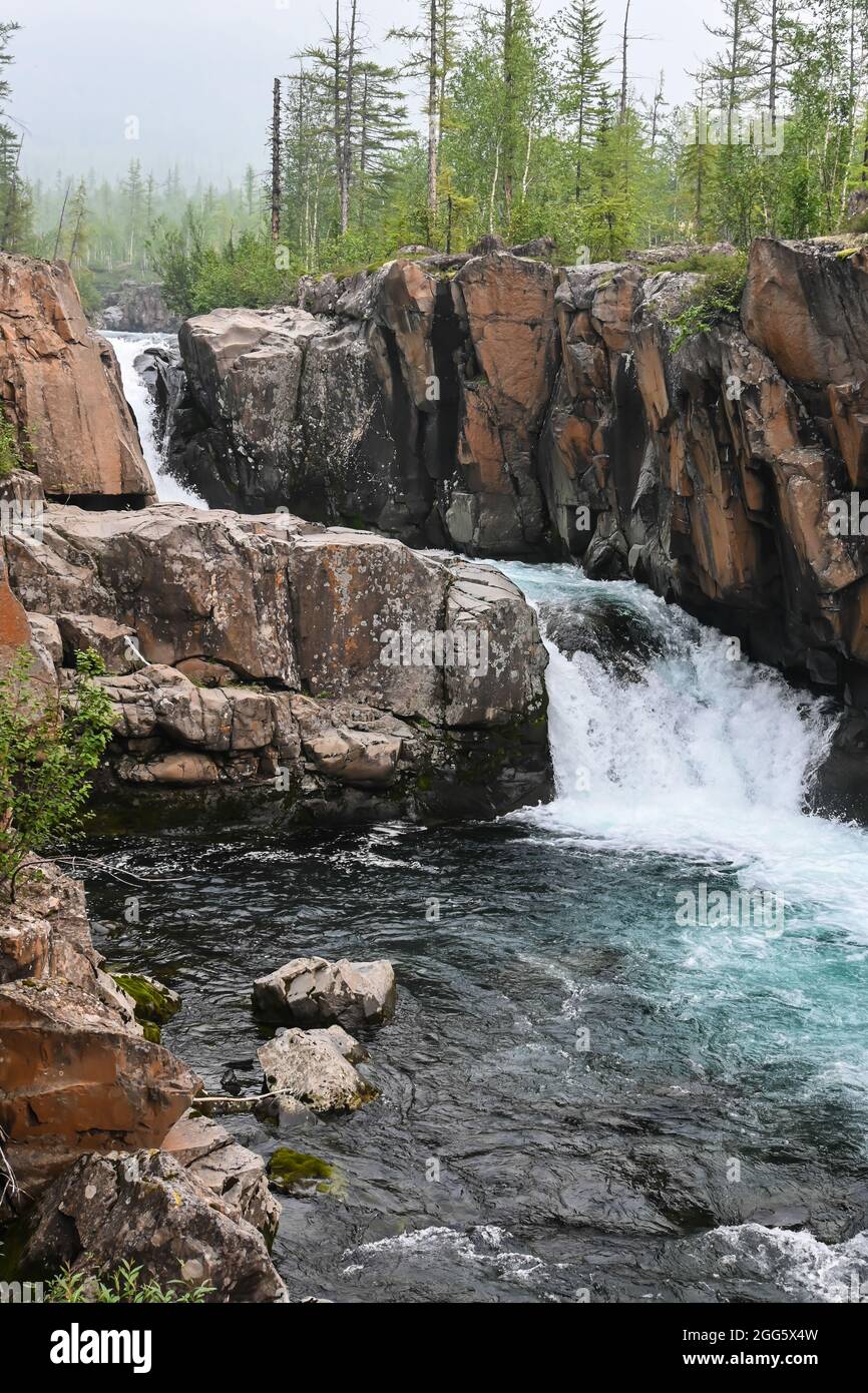 Putorana Plateau, a waterfall on the Grayling Stream. Mountain stream on a  cloudy day Stock Photo - Alamy