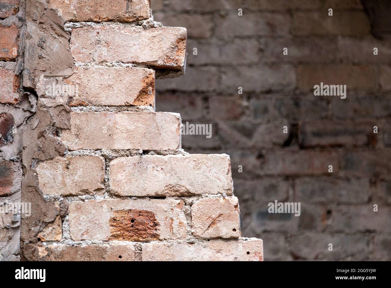 Partially removed brick wall at a renovation of an old brick house Stock Photo