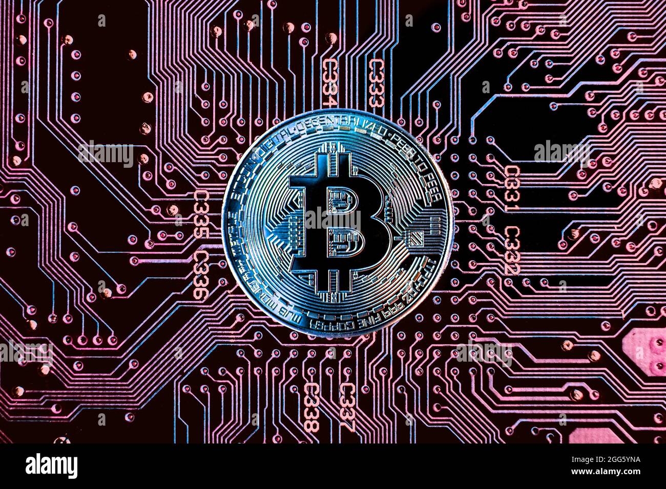 Bitcoin cryptocurrency token coin against circuit board background Stock Photo