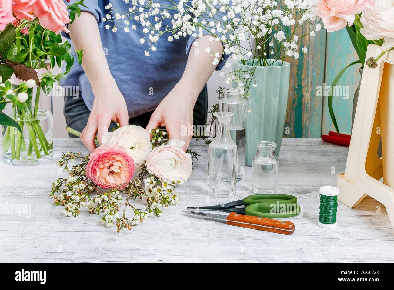 Work Sorting Roses Florist workplace: woman arranging a bouquet with roses, matthiolas ...