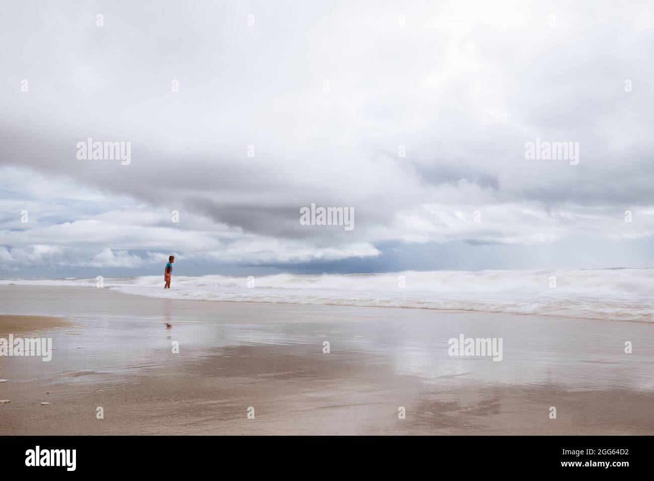 A boy stands in the water in Carolina Beach, North Carolina. Stock Photo