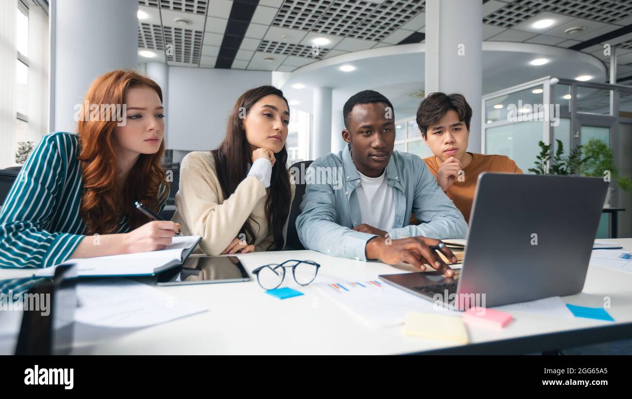 Diverse goup of focused multicultiral people using pc at office Stock Photo