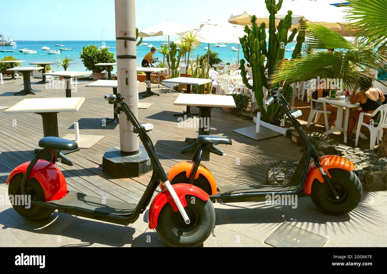 Electric scooters outside a restaurant on Corralejo Beach in Fuerteventura one of the Cana Stock Photo