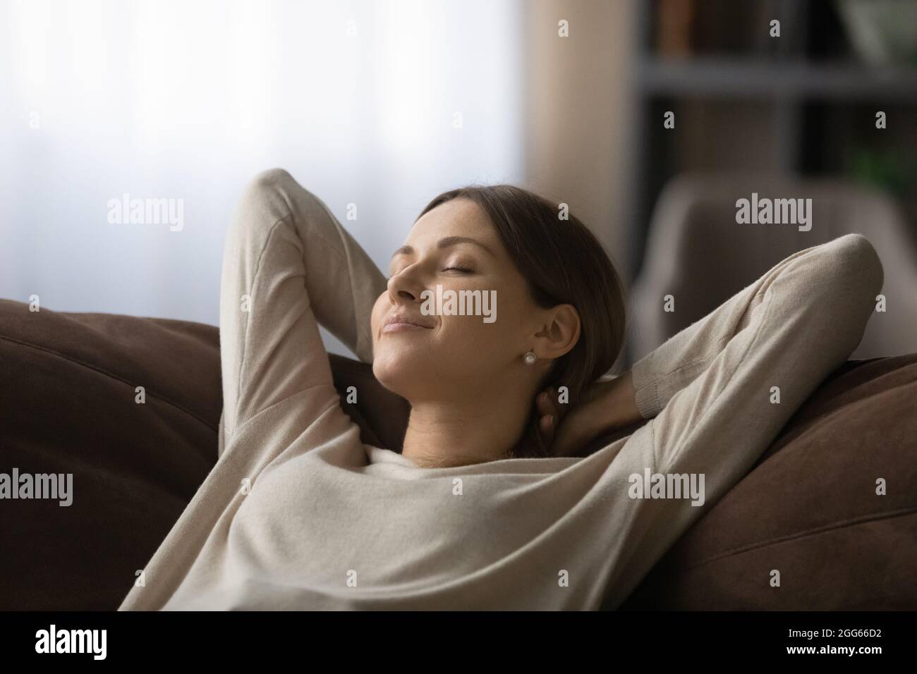Close up peaceful woman with closed eyes relaxing on couch Stock Photo ...