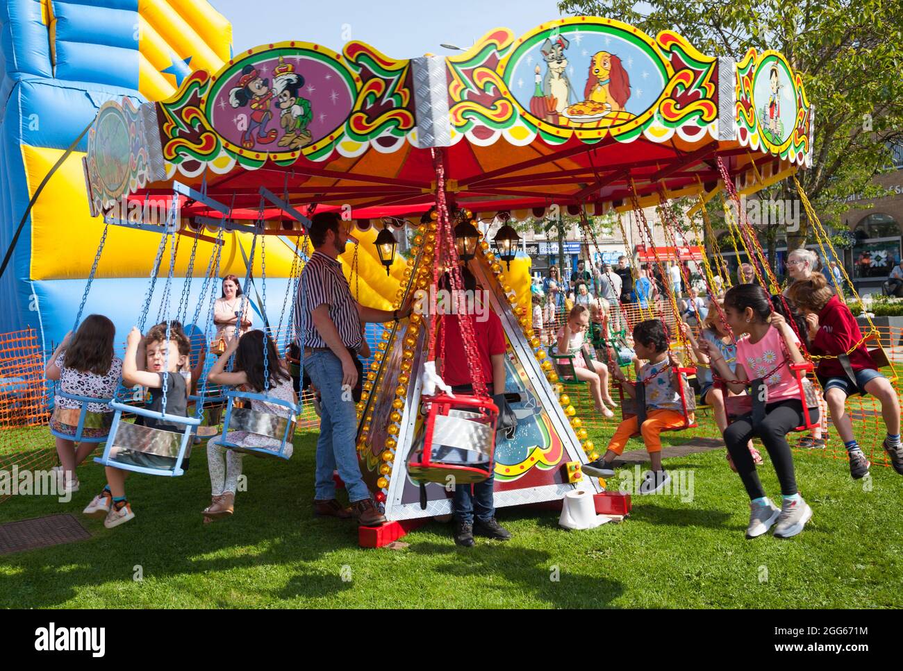 Children on swing chair merrygoround at Summer Fayre, Helensburgh