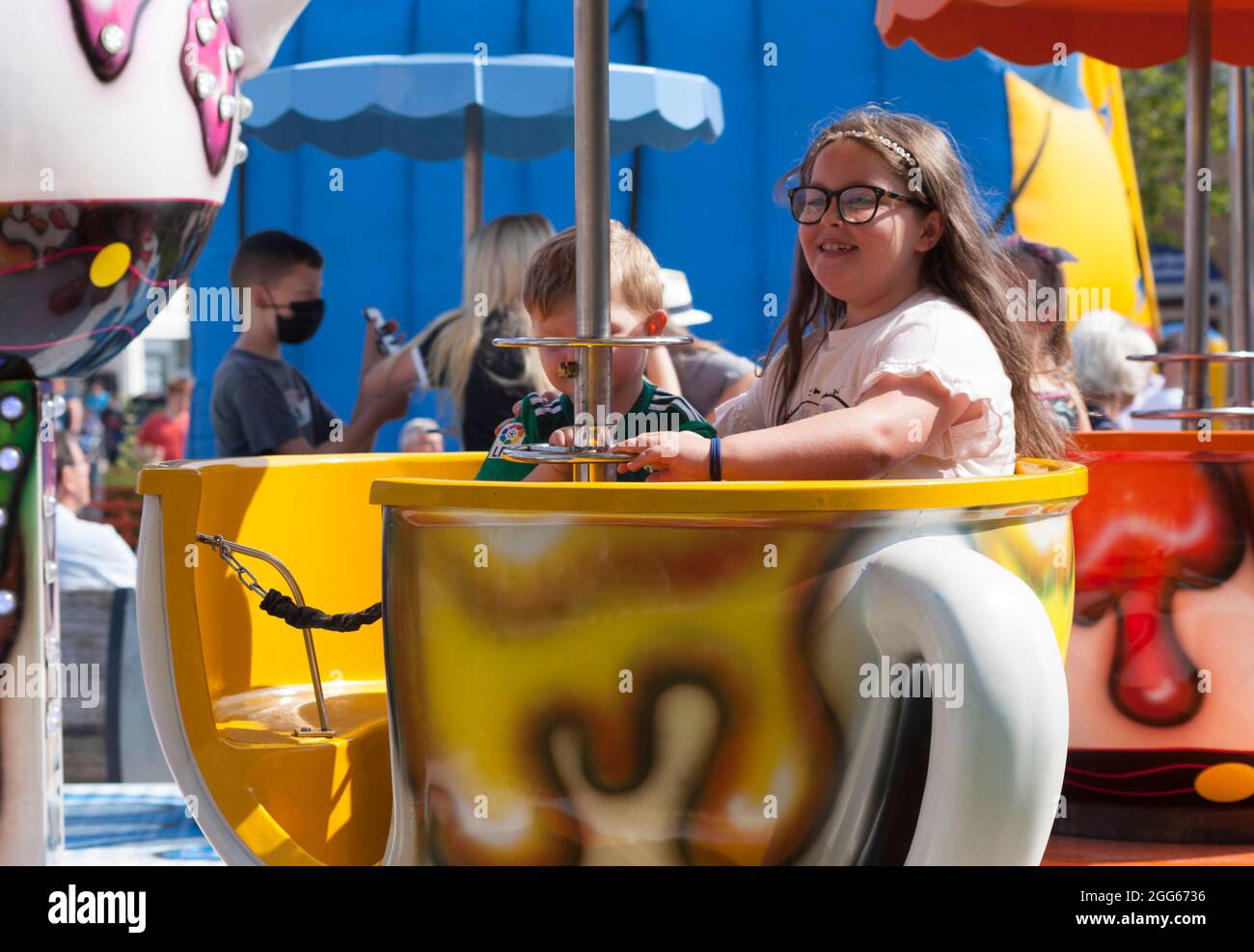 Girl on teacup ride at the Summer Fayre, Helensburgh, Scotland Stock Photo