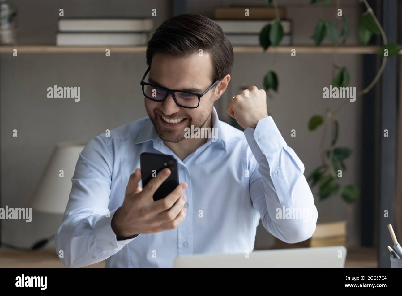 Excited young businessman celebrating success hi-res stock photography ...
