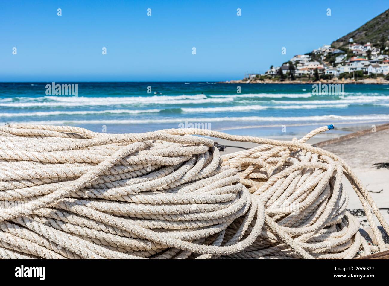 Beachy Net Rope traditional fishing net and rope on small rowing boat on beach Stock ...