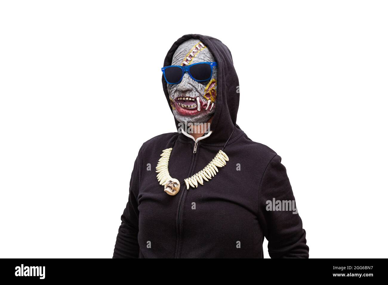 A man disguised in a zombie mask wearing a black hooded sweatshirt is wearing sunglasses with blue frames. Stock Photo