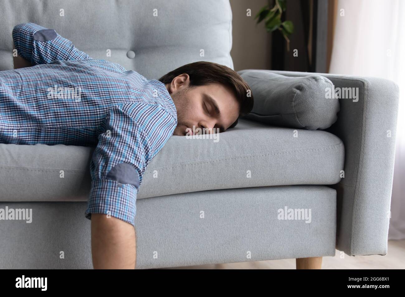 Tired millennial guy in casual sleeping at daytime Stock Photo