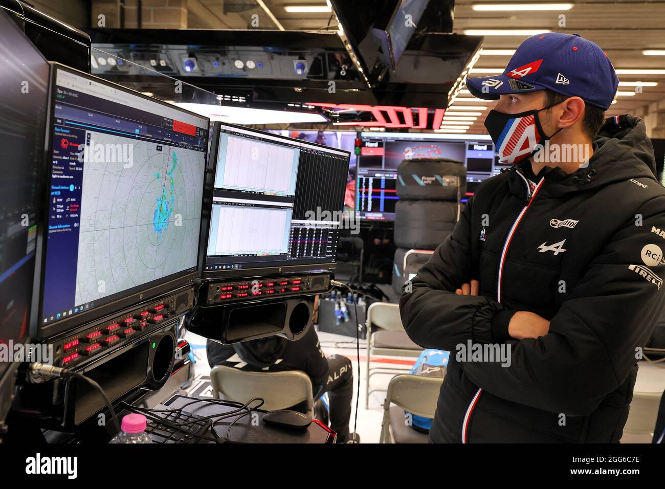 Esteban Ocon (FRA) Alpine F1 Team looks at the weather radar in the pits as  the race is suspended. Belgian Grand Prix, Sunday 29th August 2021.  Spa-Francorchamps, Belgium Stock Photo - Alamy