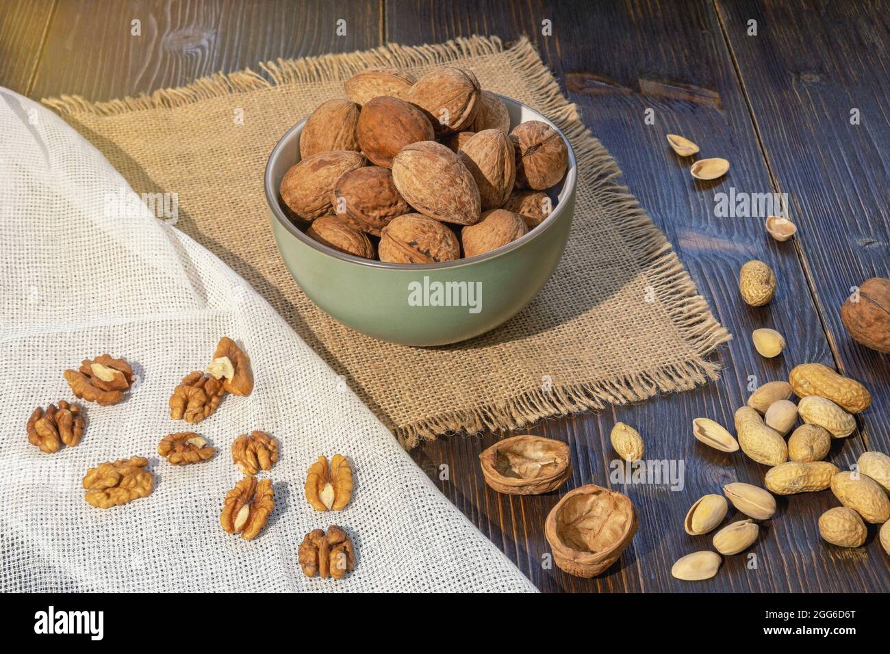 Nuts. Whole walnuts and kernels on dark rustic table Stock Photo