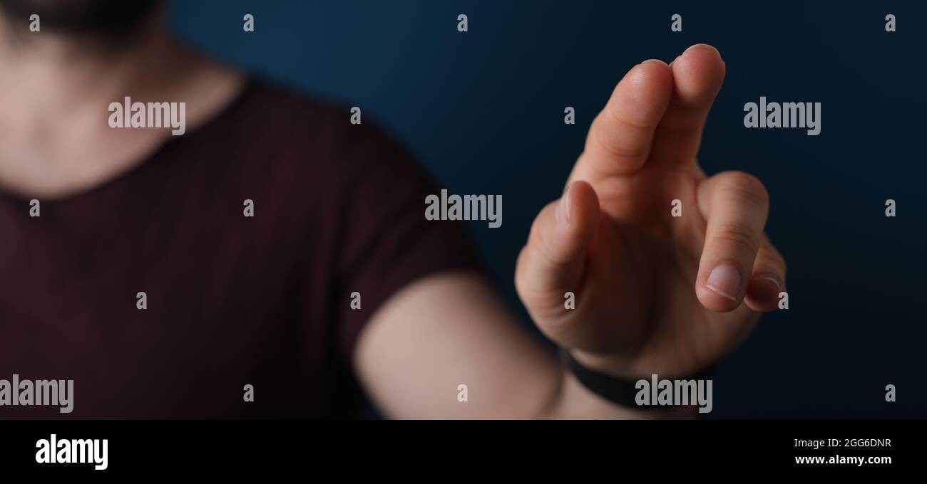 A closeup shot of a man's hand touching with finger Stock Photo