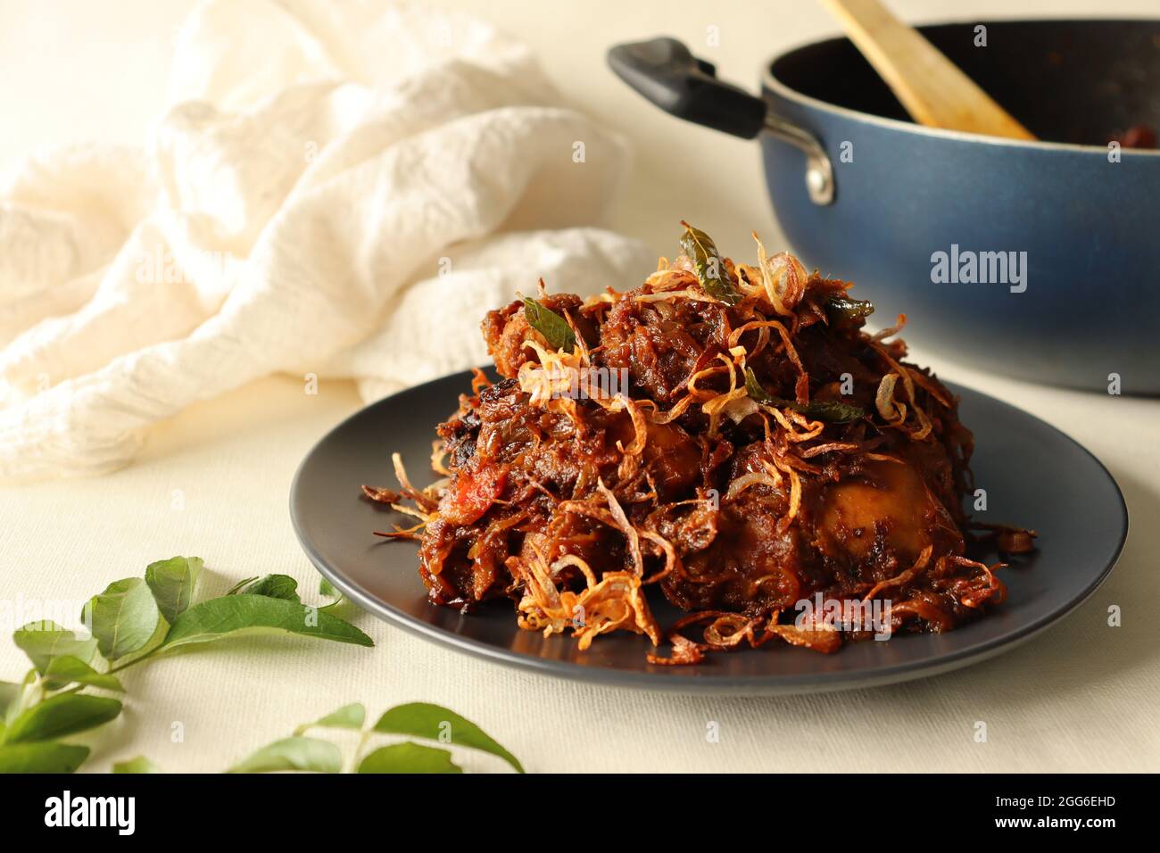 Kerala style spicy chiken roast garnised with caramalised onions
