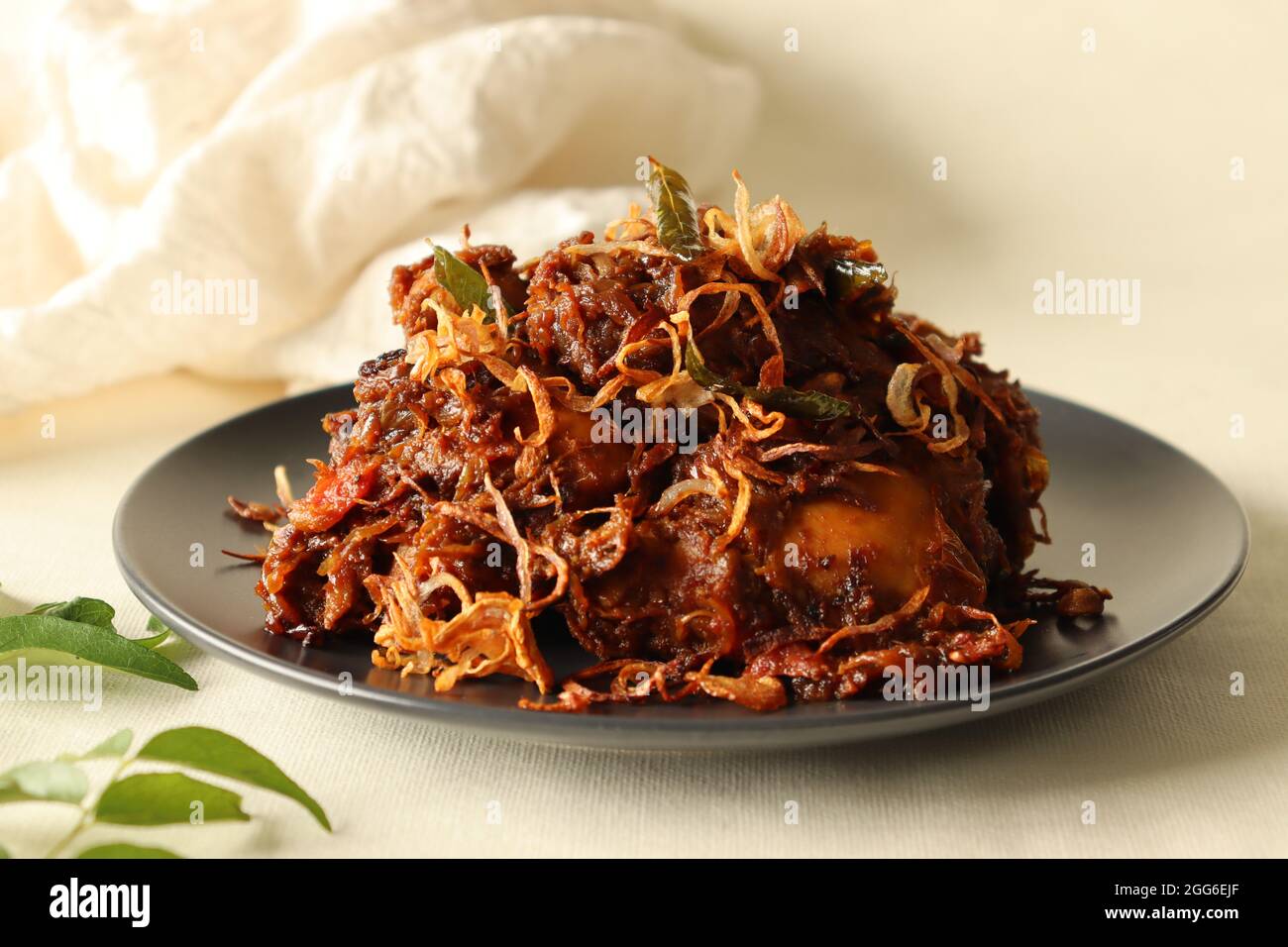 Kerala style spicy chiken roast garnised with caramalised onions