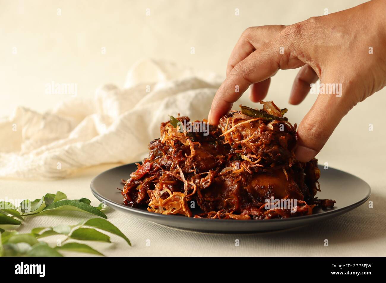 Kerala style spicy chiken roast garnised with caramalised onions