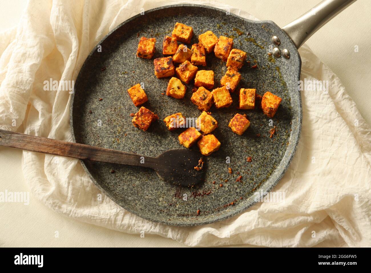 Tandoori paneer. Cottage cheese marinated with yogurt and spices and shallow fried on a griddle or non stick tawa. Shot on white background. Stock Photo