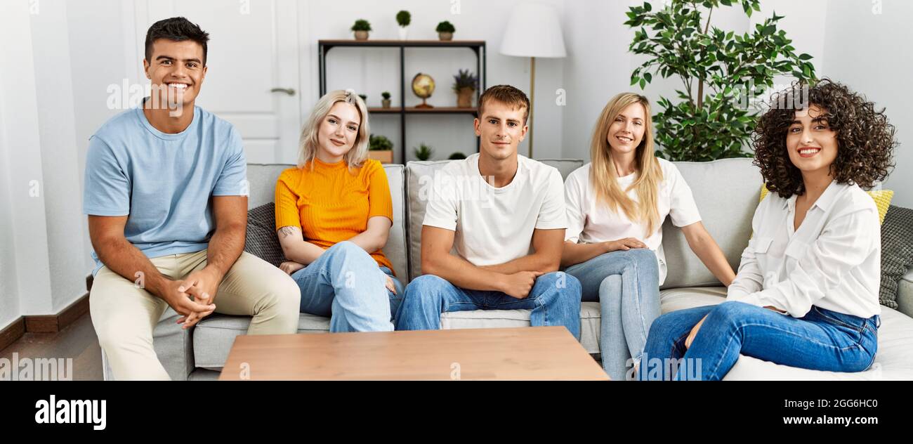 Group of young friends smiling happy sitting on the sofa at home Stock ...