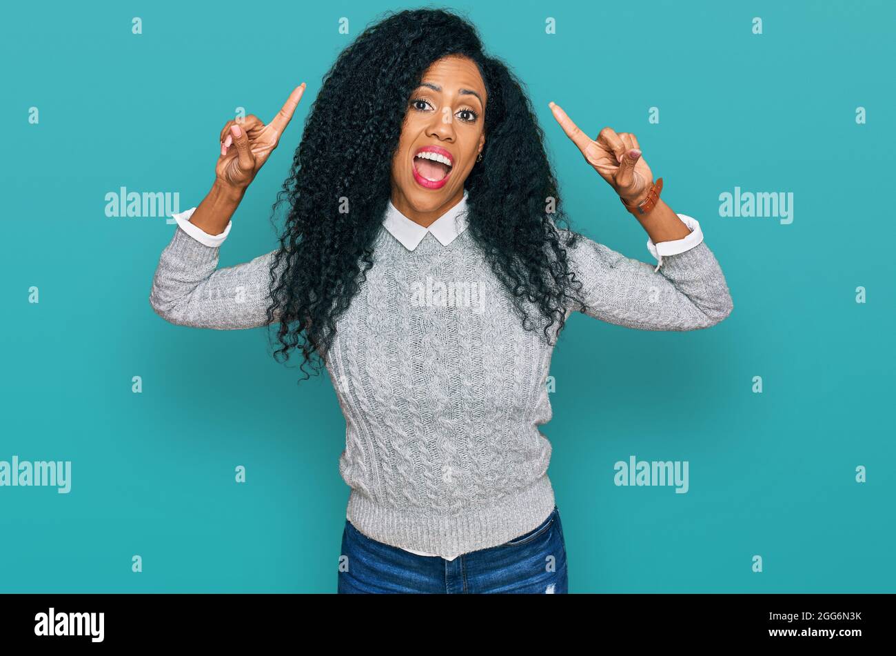 Middle age african american woman wearing casual clothes smiling amazed ...