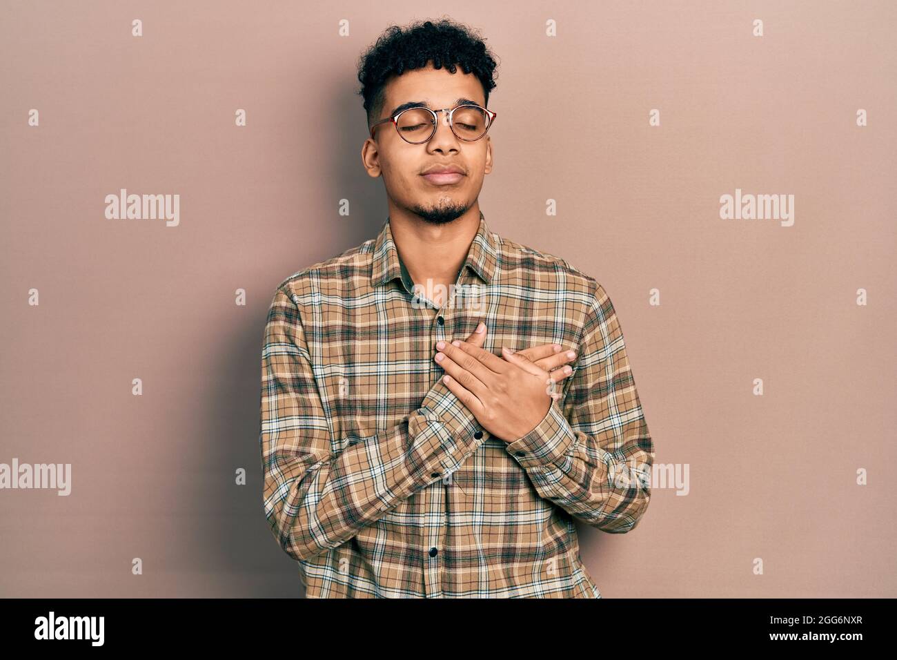 Young african american man wearing casual clothes and glasses smiling ...