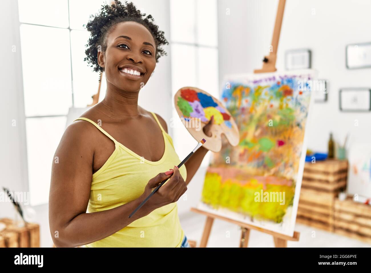 Young african american artist woman smiling happy drawing at art studio ...