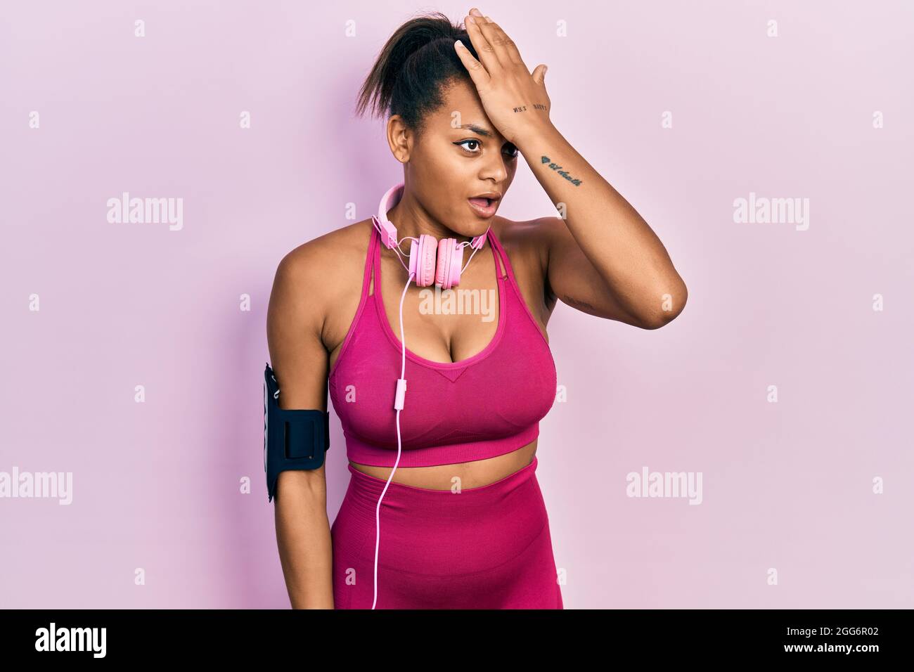 Young african american girl wearing gym clothes and using headphones