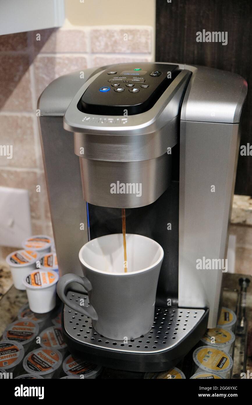 https://c8.alamy.com/comp/2GG6YXC/single-cup-or-k-cup-keurig-coffee-maker-making-hot-coffee-in-a-family-residential-kitchen-2GG6YXC.jpg