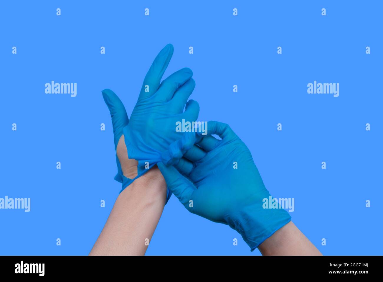 Woman hands taking off torn blue rubber gloves Stock Photo Alamy