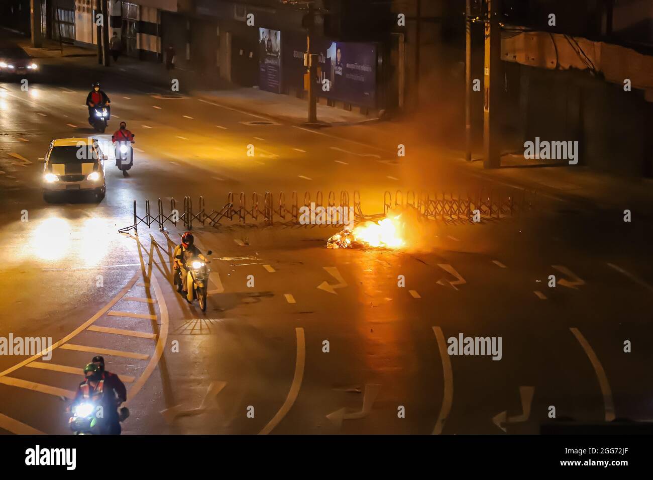 Bangkok, THAILAND - August 22, 2021: Anti-government protesters burn things to block the road for prevent Riot police come crack down. Stock Photo