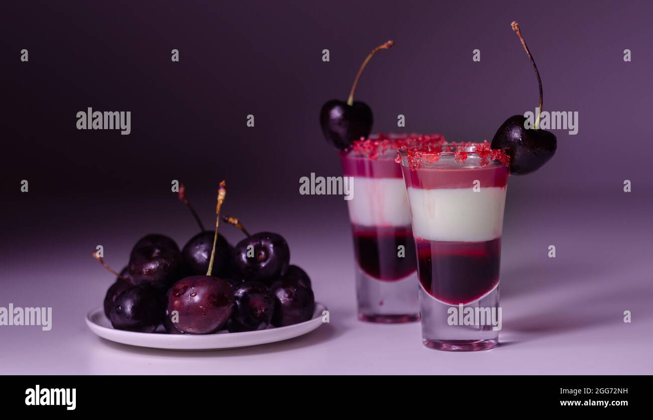 Threelayer cocktail based on vodka, cherry liqueur and syrup in drink