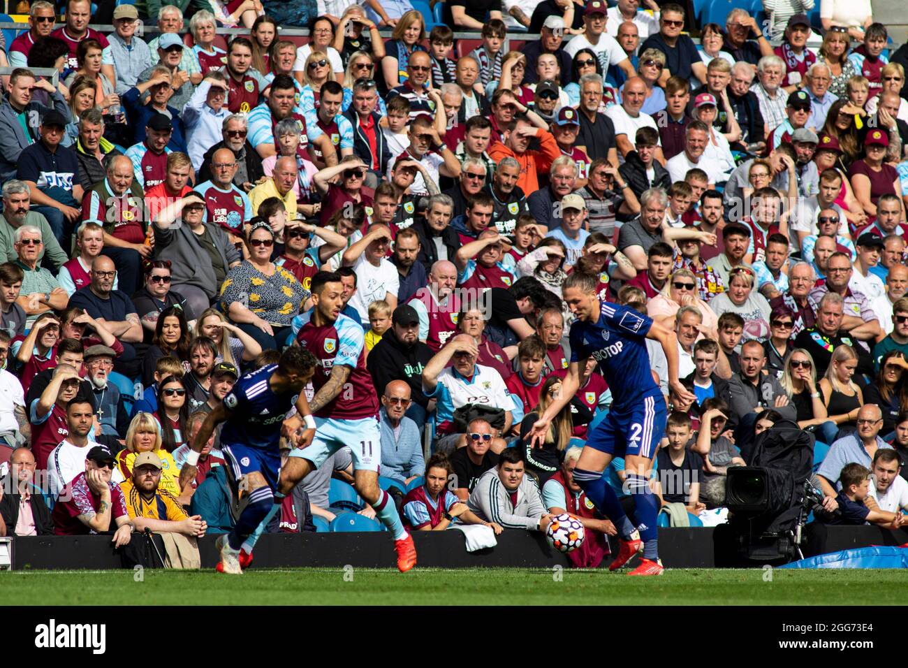 The crowd watch Luke Ayling of Leeds United (R) Premier League match, Burnley v Leeds Utd at Turf Moor in Burnley, Lancs on Sunday 29th August 2021. this image may only be used for Editorial purposes. Editorial use only, license required for commercial use. No use in betting, games or a single club/league/player publications. pic by Lewis Mitchell/Andrew Orchard sports photography/Alamy Live news Credit: Andrew Orchard sports photography/Alamy Live News Stock Photo