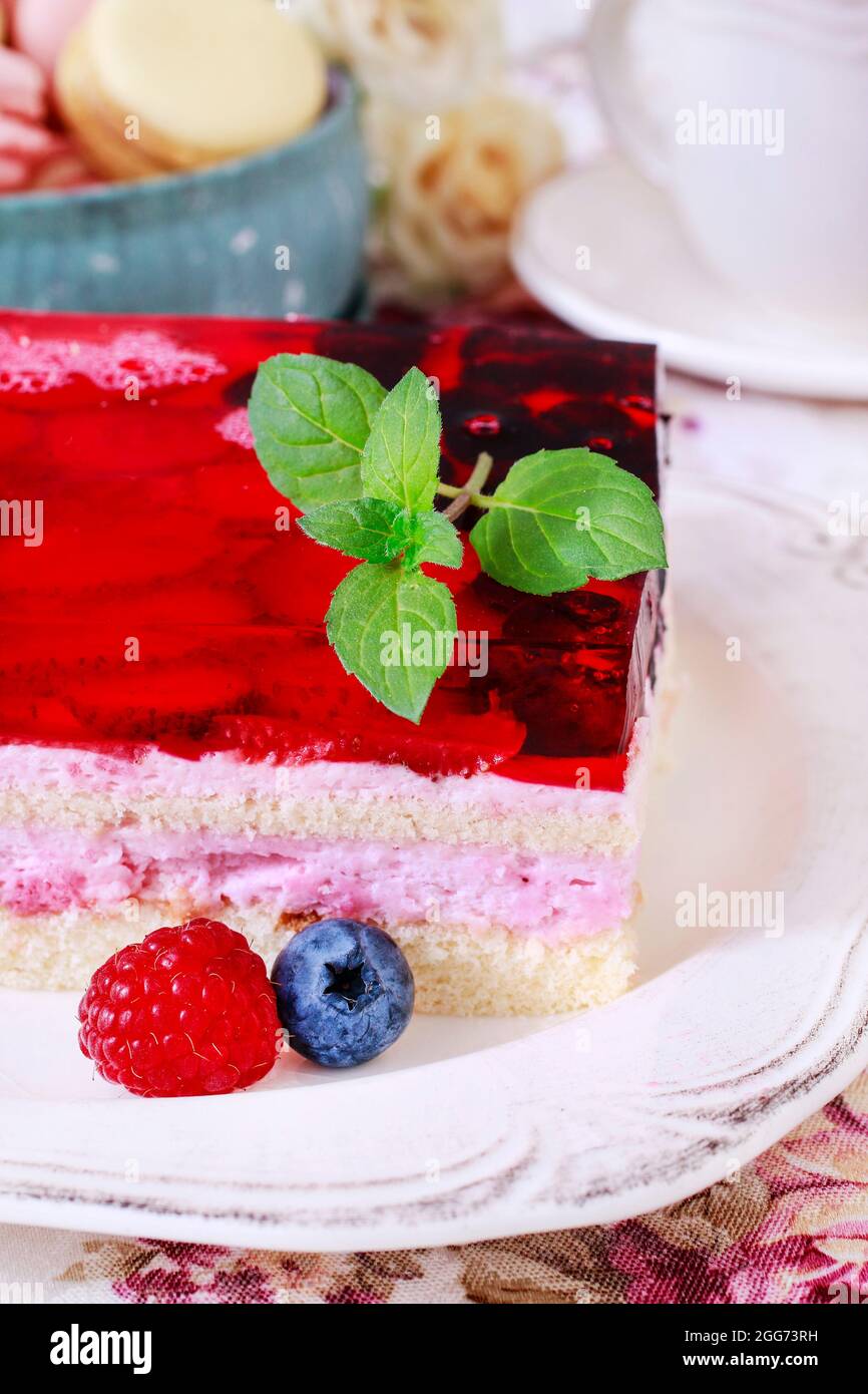 Layer fruit cake decorated with lemon balm leaf.  Party dessert Stock Photo