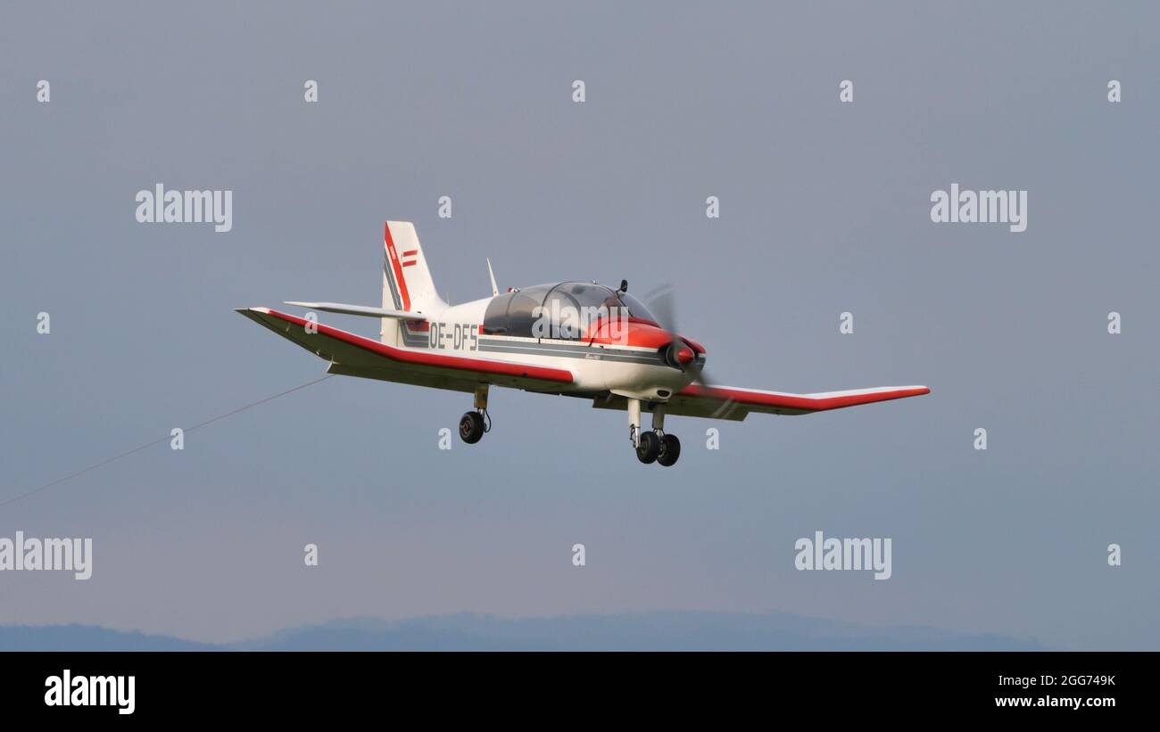 Thiene, Italy JULY, 8, 2021 Propeller plane used for towing gliders lands. Robin DR400 Stock Photo