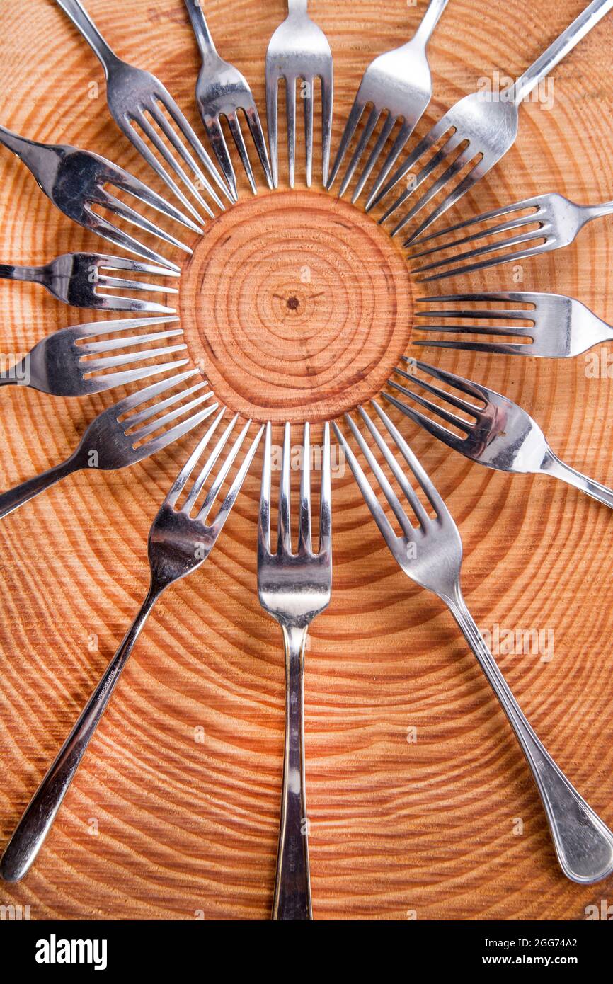 Series of different forks in a circle of pine board Stock Photo Alamy