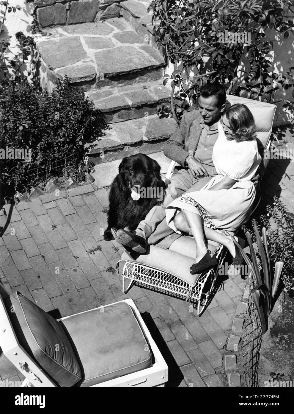 HUMPHREY BOGART and his 3rd Wife MAYO METHOT with their Newfoundland Dog Captain Kidd in 1940 at his home on Shoreham Drive Los Angeles publicity for Warner Bros. Stock Photo