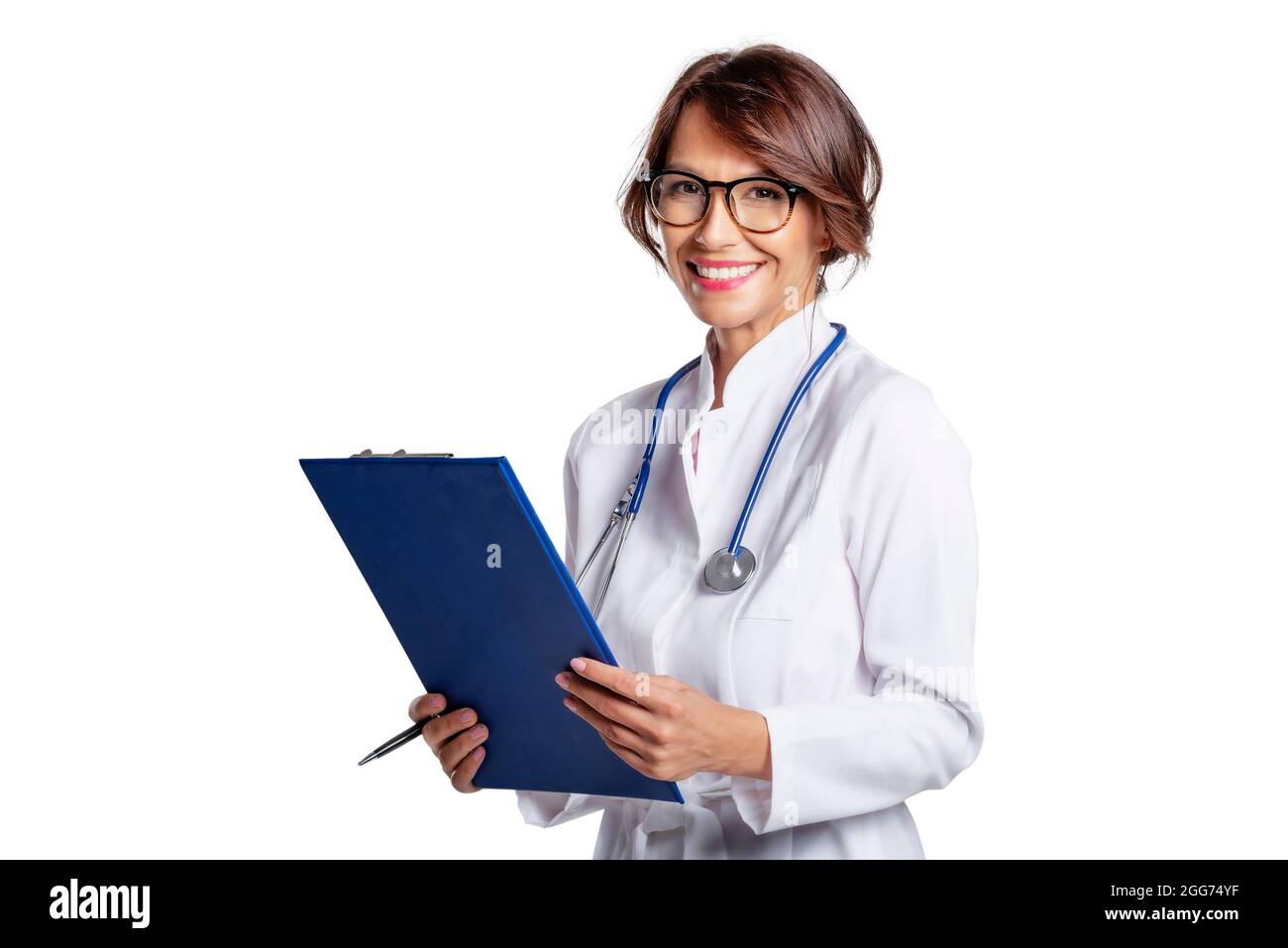 Smiling female doctor holding clipboard in her hand while looking at ...