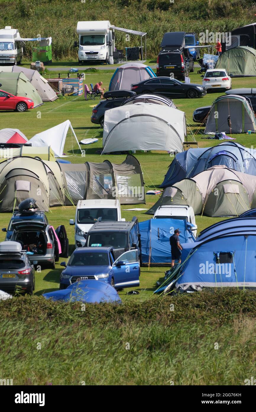 Gower, Swansea, UK. 29th August 2021. UK Weather. Campsites are full as staycationers enjoy a hot and sunny bank holiday weekend at Llangennith on the Gower peninsula. The rest of the holiday weekend is forecast to be similarly fine in the south. Credit: Gareth Llewelyn/Alamy Stock Photo