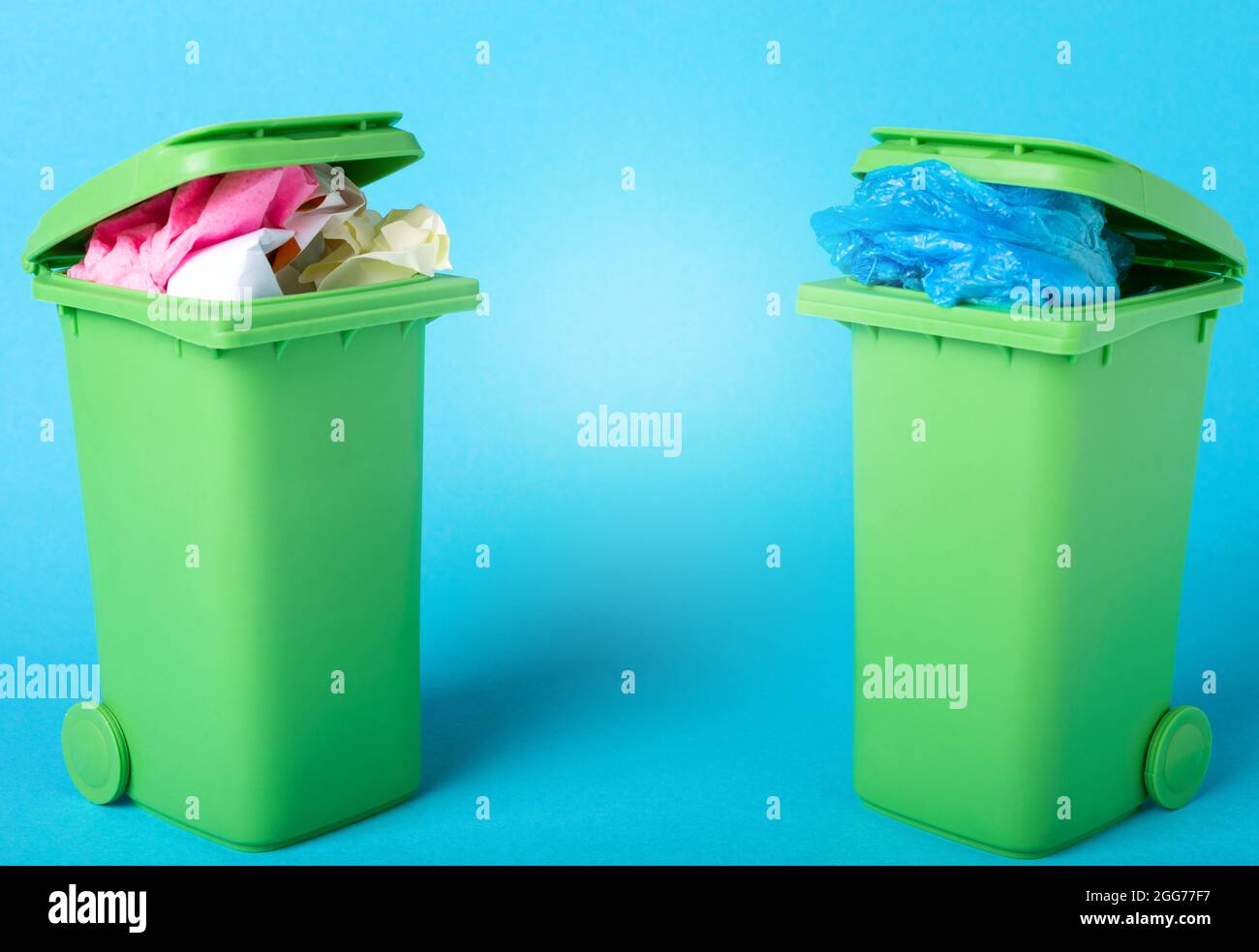 Recycle bins on blue background. Paper and polyethylene. Waste