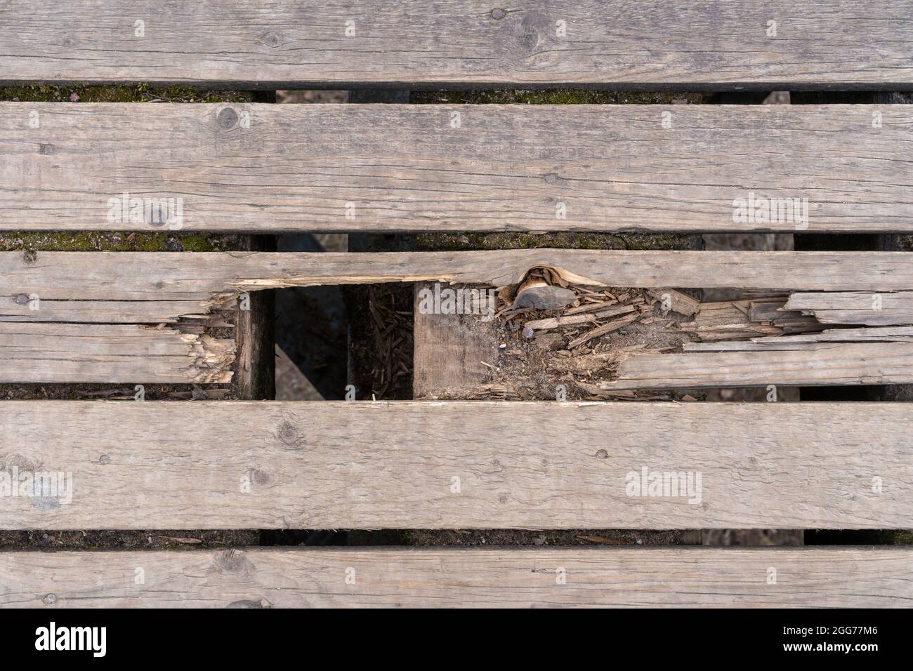 Wooden construction floor with a broken section. View from above of a