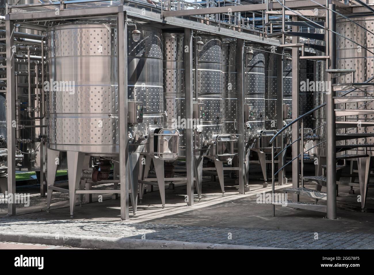 Stainless steel barrels for wine fermentation at a winery. Wine production industry concept