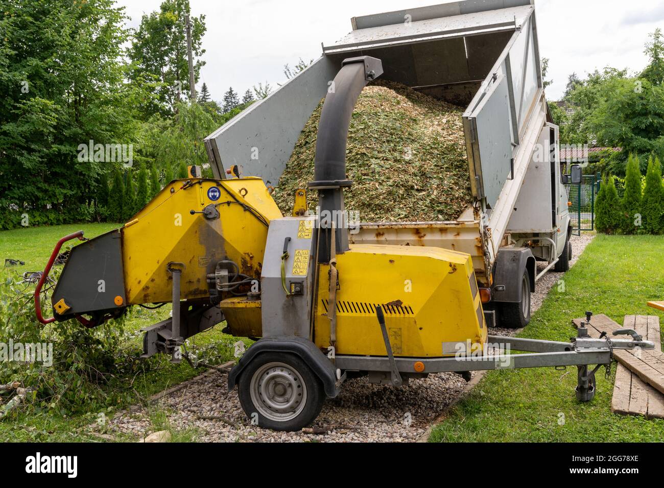 a branch chipper at the arborist's dump truck performing chip branching