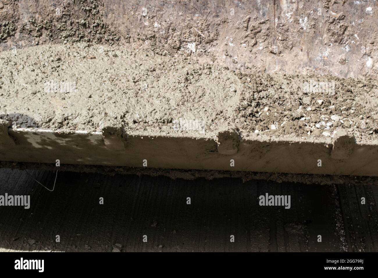 Excavator at a construction site. Bucket with cement. Heavy construction equipment. Stock Photo