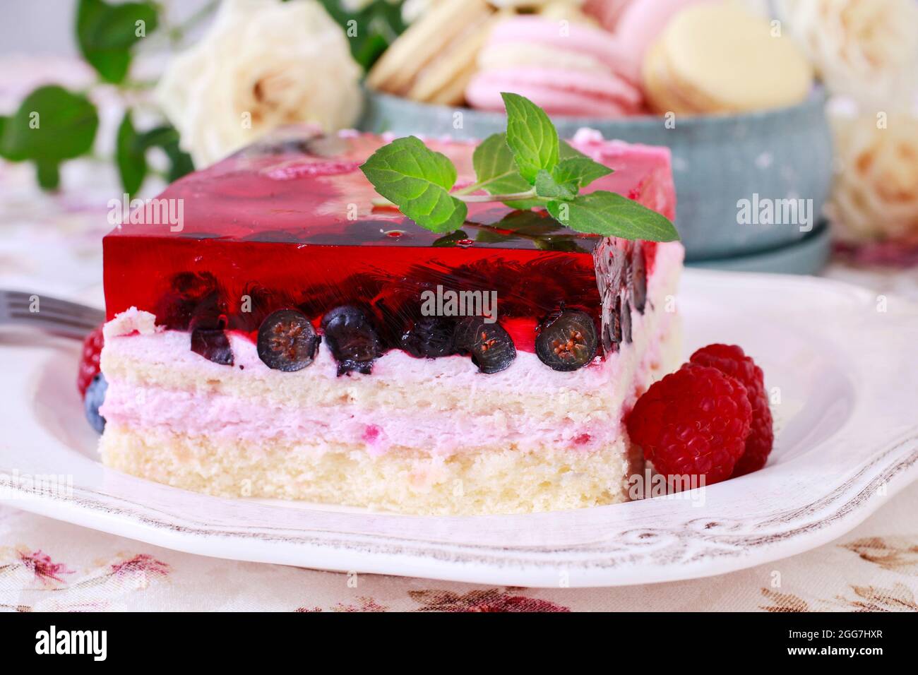 Layer fruit cake decorated with lemon balm leaf. Party dessert Stock Photo