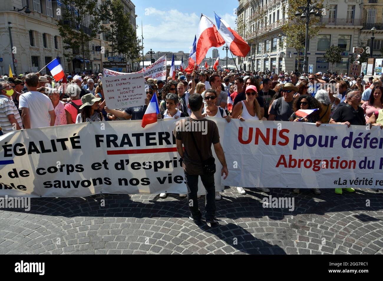 Marseille, France. 28th Aug, 2021. Protesters hold a banner expressing  their opinion during the demonstration. Thousands of people demonstrated  against the health pass in Marseille, France. French President Emmanuel  Macron announced among