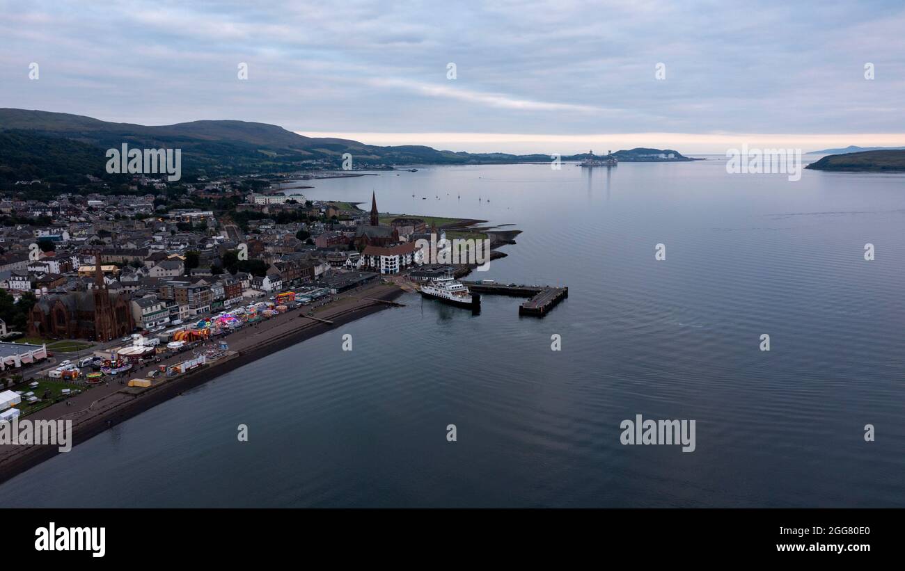 Largs, UK. 29th Aug, 2021. Pictured: Aerial view looking down from above taken with a drone of Largs beach front showing the relatively busy scene of the fair ground and shows and amusement arcade where the covid infection rate has been at an all time high in Scotland since records began. Credit: Colin Fisher/Alamy Live News Stock Photo