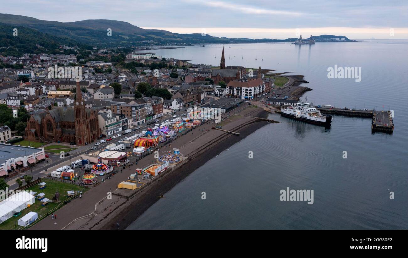 Largs, UK. 29th Aug, 2021. Pictured: Aerial view looking down from above taken with a drone of Largs beach front showing the relatively busy scene of the fair ground and shows and amusement arcade where the covid infection rate has been at an all time high in Scotland since records began. Credit: Colin Fisher/Alamy Live News Stock Photo