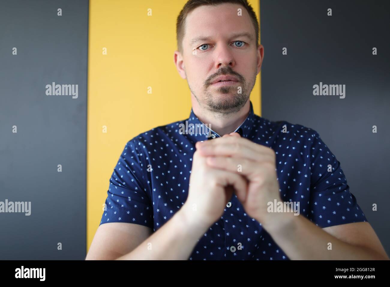 Young man folding his hands and pray Stock Photo