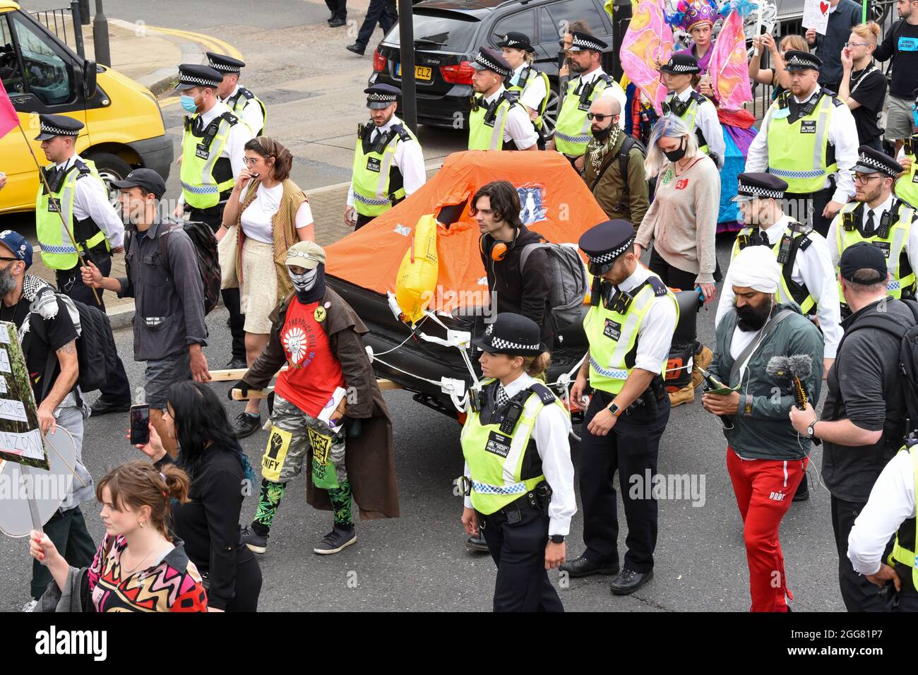 Police Life Raft Police surround an inflatable life raft on a cart as its pulled along ...