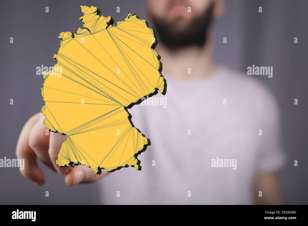 A 3D rendered map of Germany against a real person Stock Photo - Alamy